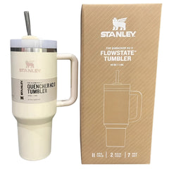 Stanley Quencher H2.0 FlowState tumbler with beige finish next to its packaging box.
